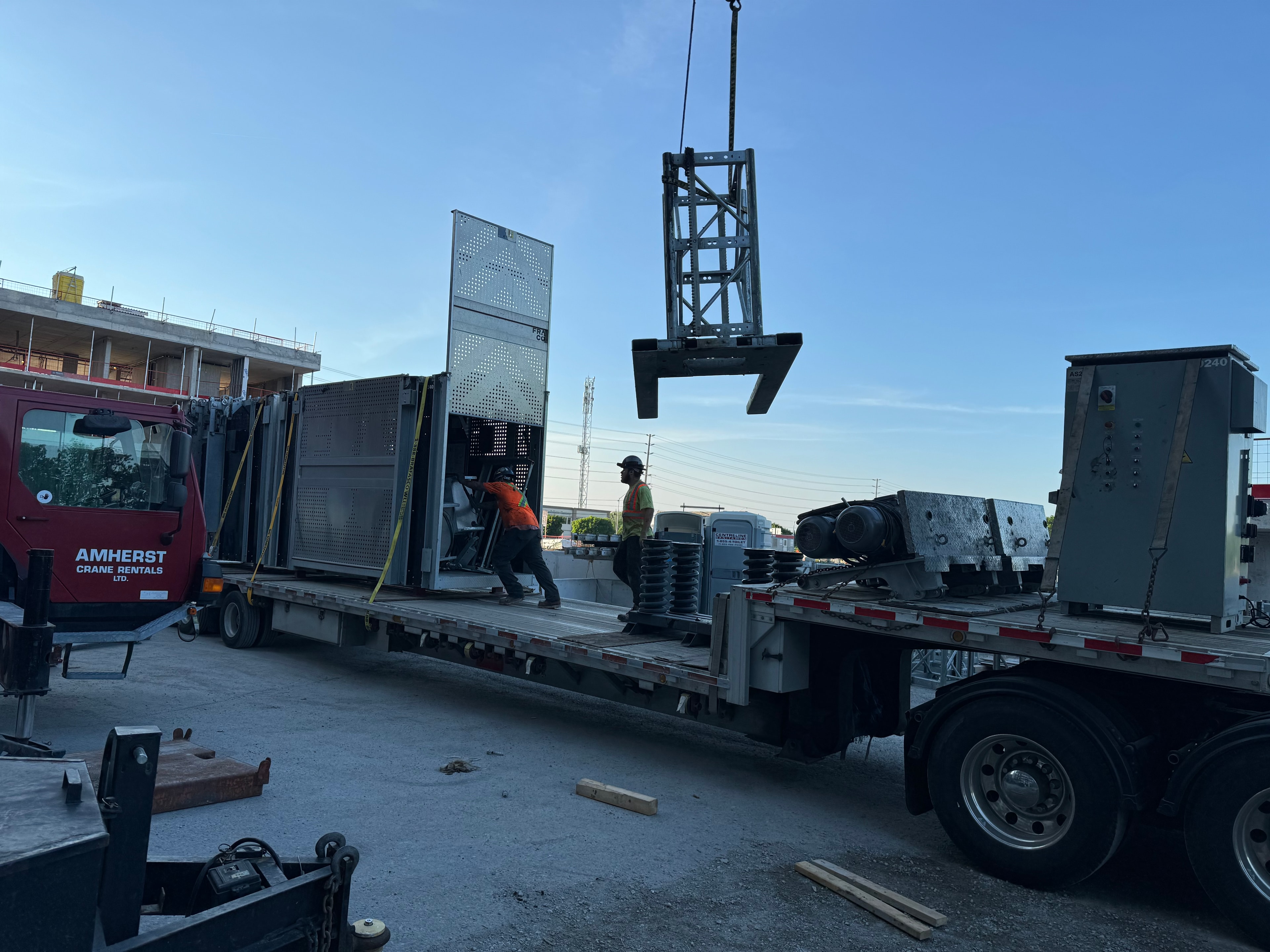 Construction elevator installation on high-rise job site